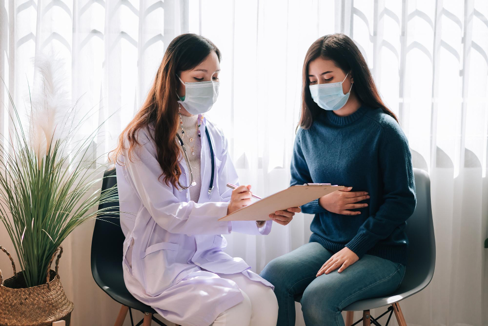 A doctor shows a patient her notes.