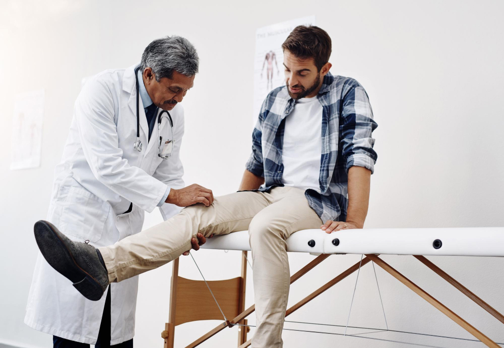 A doctor checks his patient's knee.