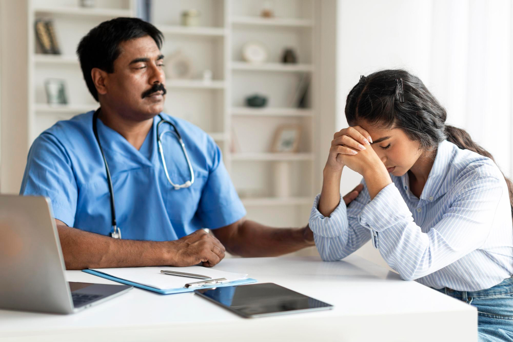 Doctor helping stressed young lady.